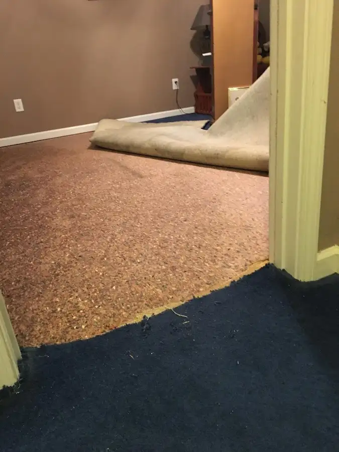 Carpet pad removal revealing water damage during Water Mitigation Services in Parkway
